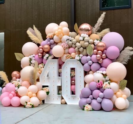 An eye-catching display for a 40th birthday celebration is presented against a dark wooden backdrop.