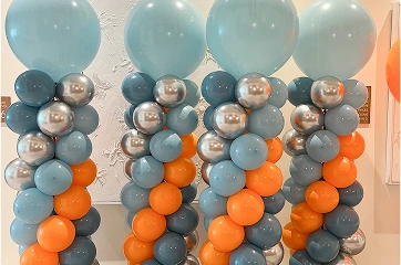our balloon columns are arranged in a row, each topped with a large, light teal/blue balloon.