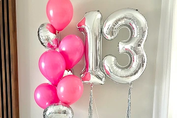 The image shows a vibrant display of balloons arranged for a 13th birthday celebration.